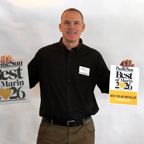 Man in black shirt holding Best of Marin 2026 awards for best solar installer from Pacific Sun.