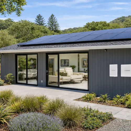 Modern gray house with solar panels on roof and batter back up in marin county