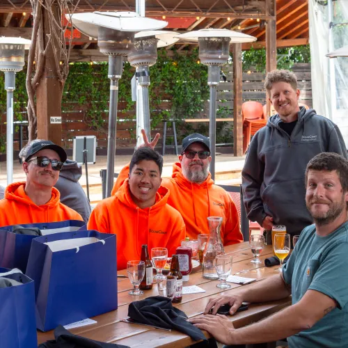 Yan Stastny et al. sitting at a table with drinks