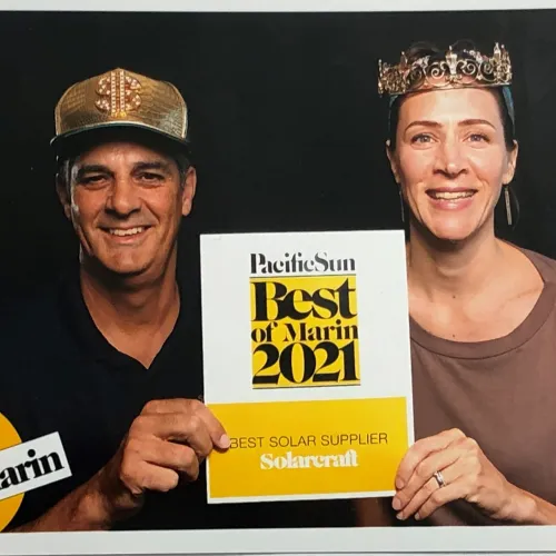 a man and woman holding a sign