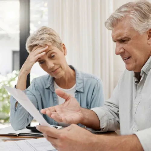 a man and a woman looking at a paper