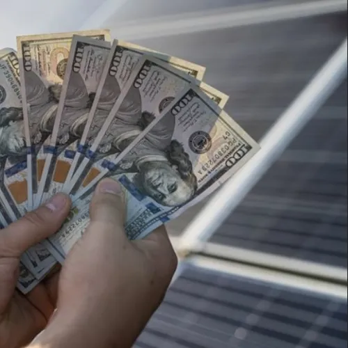 a hand holding a stack of paper money
