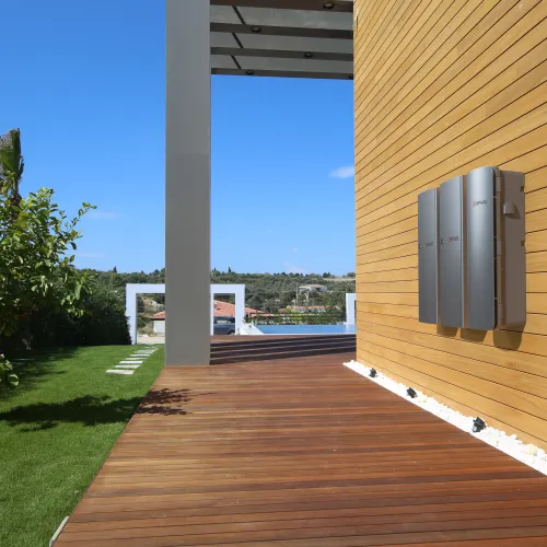 a deck with a wood deck and a tree and a building