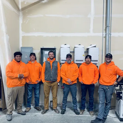 a group of people wearing orange jackets
