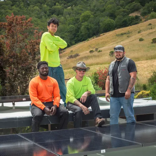 a group of men posing for a photo on a roof