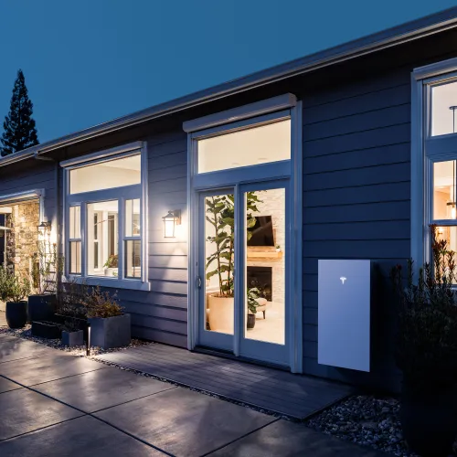 modern home with tesla powerwall battery during power outage and lights are on