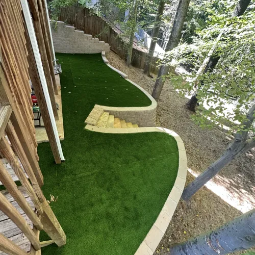 a backyard with a deck and trees