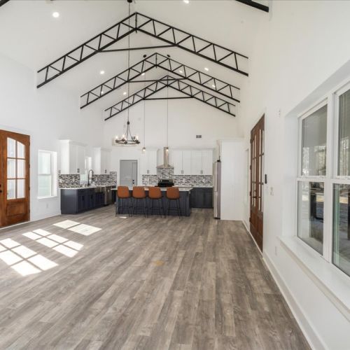a large white room with a wood floor and a wood floor