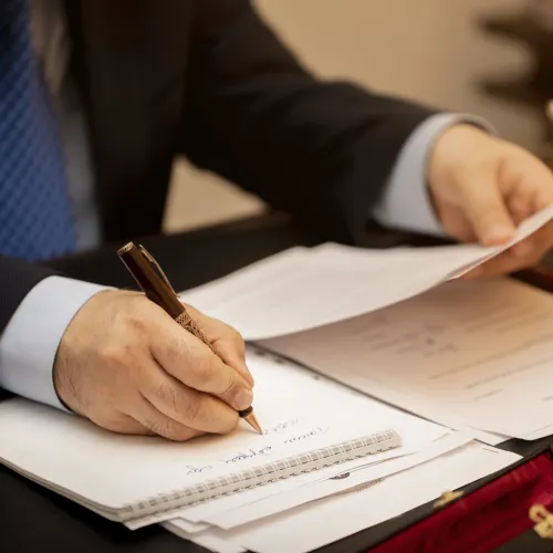 a person writing on a piece of paper