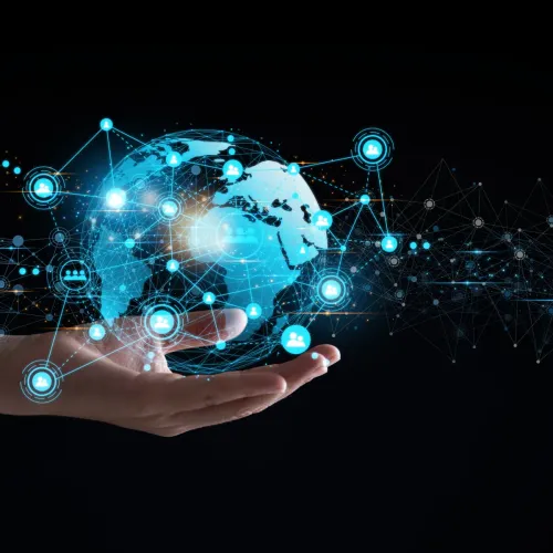 Hand holding a digital globe with interconnected network icons representing global communication and technology.