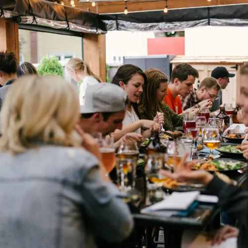 a group of people eating at a restaurant
