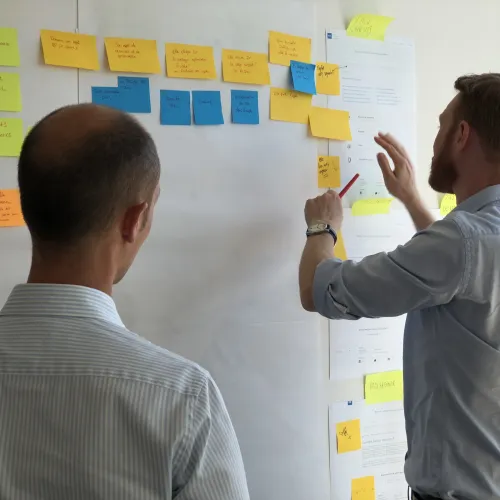 a man pointing to a whiteboard