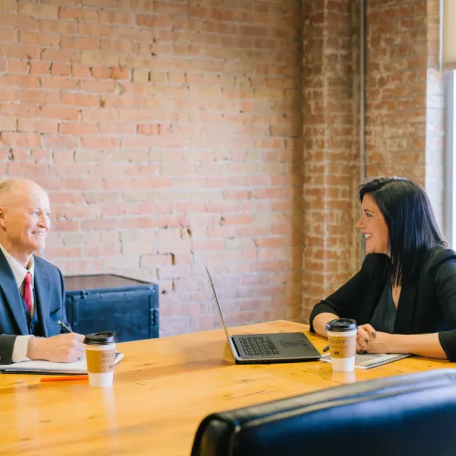 two people meeting in office over coffee