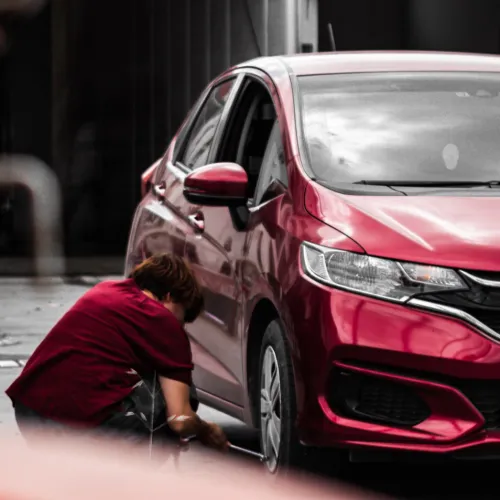 a person leaning on a car