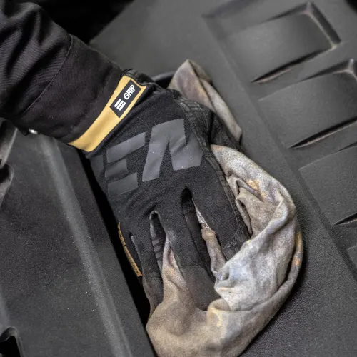 a gloved hand holding a black and white object