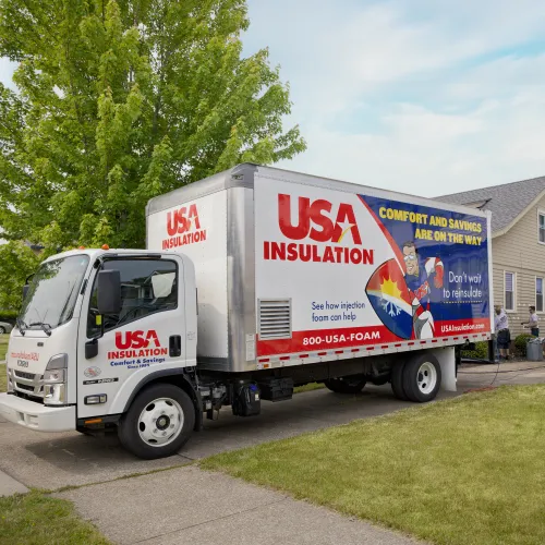 A USA truck parked in front of a house