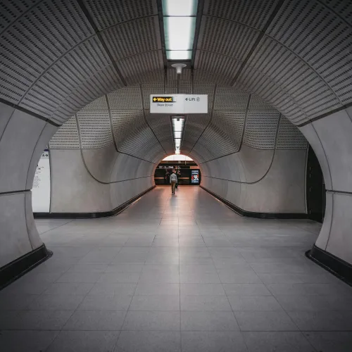 a person walking down a tunnel