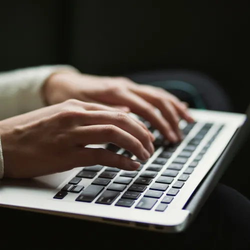 a person typing on a laptop