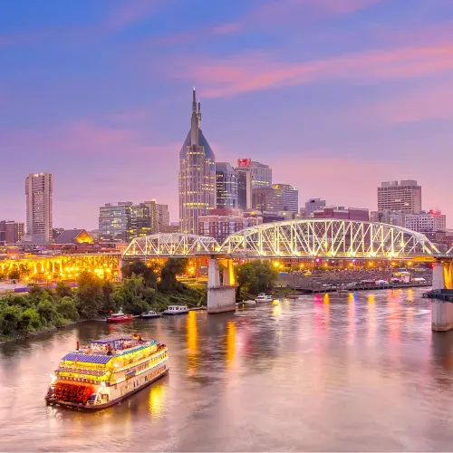 a boat on a river with a city in the background