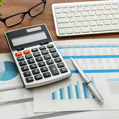 a calculator and papers on a table