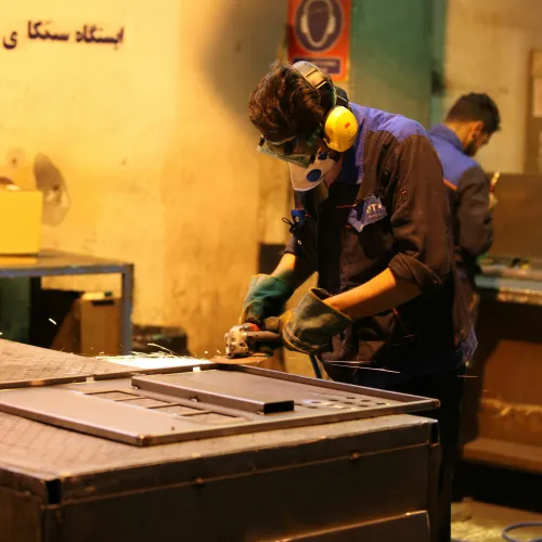 Row of white delivery vans parked along a tree-lined road under a clear sky during daytime