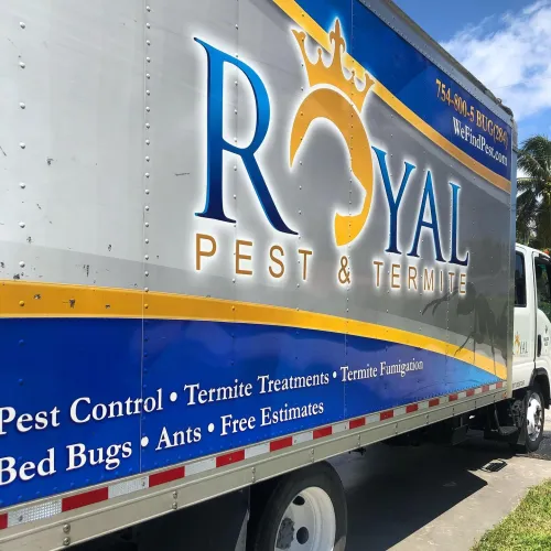 White and blue Royal Pest & Termite truck with services listed including pest control, termite treatments, and bed bugs.