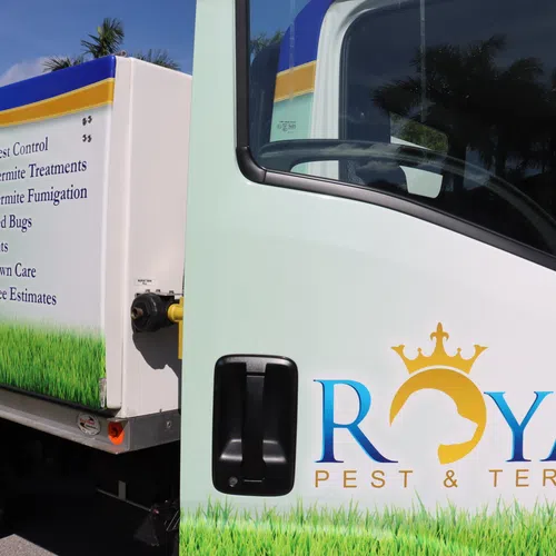 Royal Pest & Termite truck with services listed including pest control, termite treatments, bed bugs, ants, and lawn care.