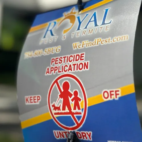 Royal Pest & Termite pesticide application sign warning to keep people and pets off treated areas.