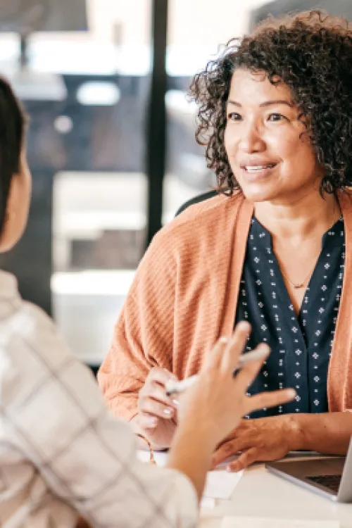 a person talking to a couple of women