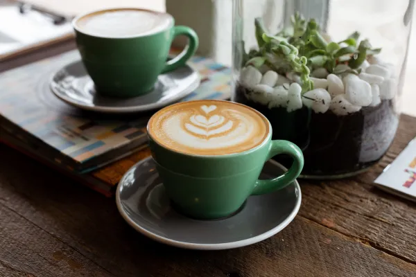 two cups of coffee on a table in a café