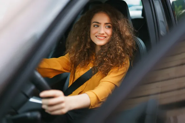 a woman leaning out of a car window