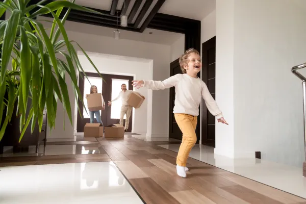 a little boy running into the new house his parents bought