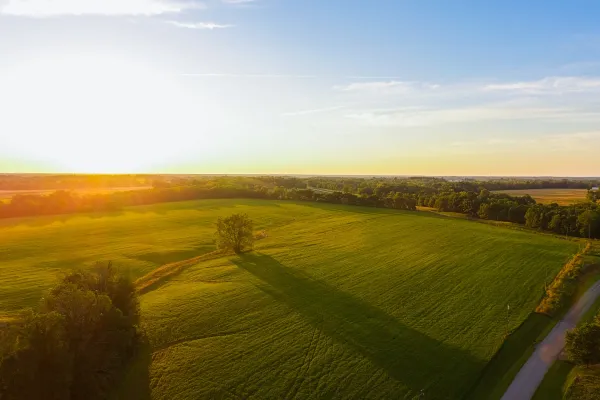 the sun rising on a large field in Ohio