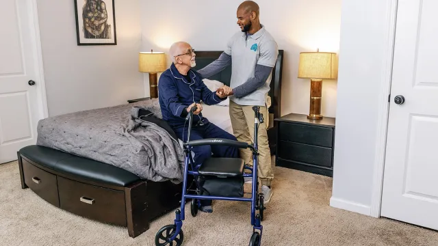a person in a wheelchair next to a person in a hospital bed