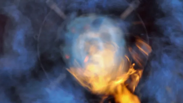 Abstract image of blue smoke and swirling orange flames creating a mysterious fiery effect.