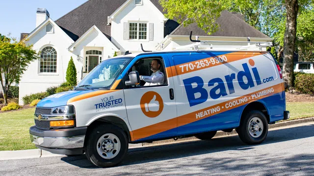 Bardi service van parked in front of a suburban home offering heating, cooling, and plumbing services.