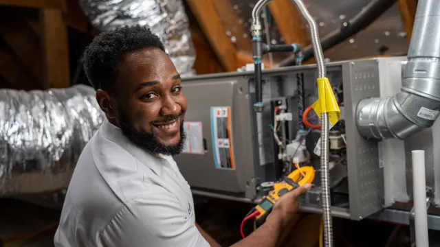 Technician installing furnace