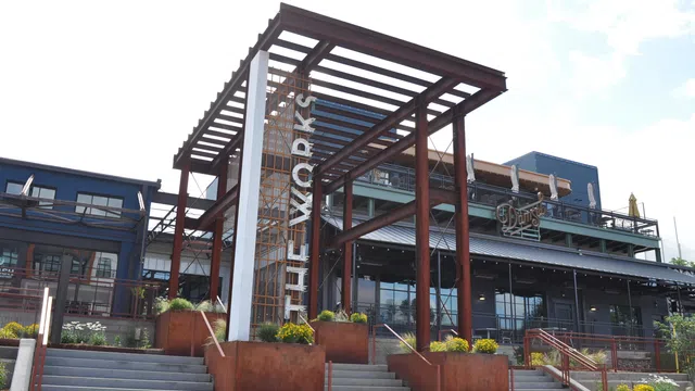 Exterior view of The Works building with modern architecture and outdoor staircases under clear sky