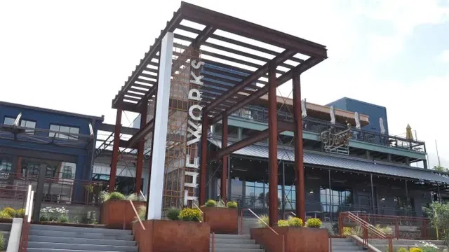 Modern entrance structure with steel beams and stairs at The Works commercial building