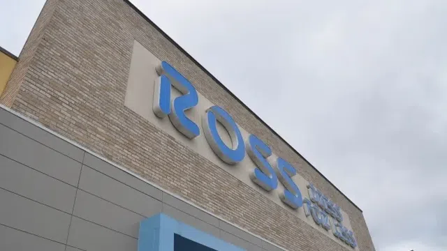 Ross Dress for Less store sign on brick and panel building under cloudy sky