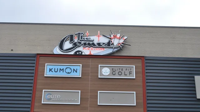 Storefront signs for Kumon, Elite Fit Golf, Elite Radiology of Georgia, and The Comet Pub & Lanes on a commercial building.