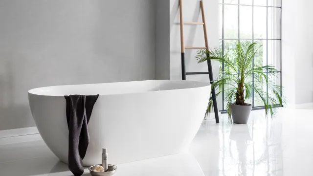 a bathtub with a towel from the side