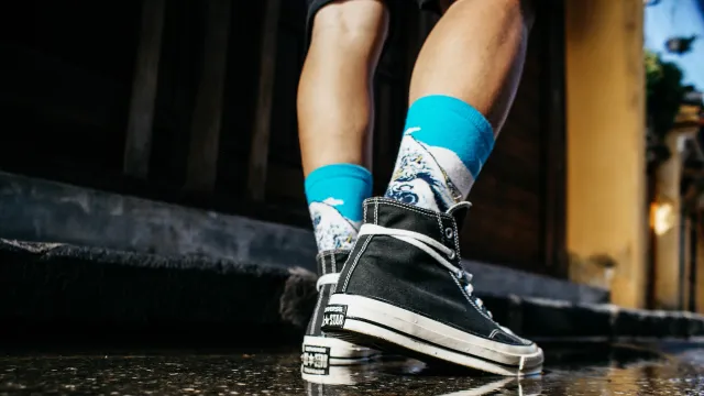 a person wearing a pair of sneakers