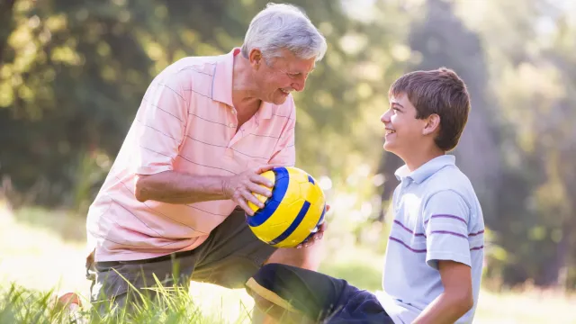 a man and a boy playing with a ball