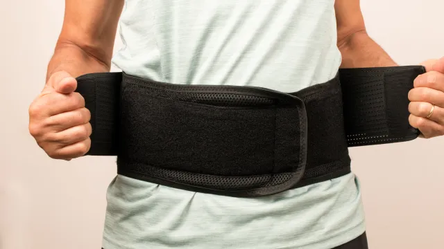 a person holding a black bag