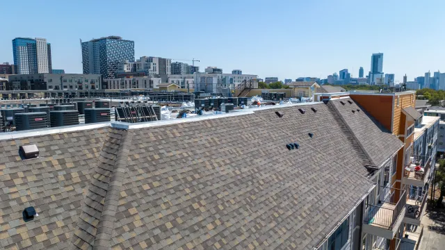a rooftop of a building with a city in the background