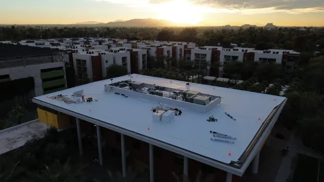 a large building with a pool in front of it