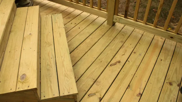 Close-up of newly built wooden deck stairs and floor with natural wood grain and railing outdoors