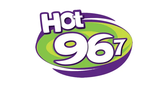 Hot 967 logo with bold white and purple text over a green and purple oval background.