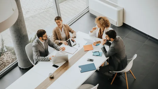 Business team engaged in a collaborative meeting at a modern conference table.